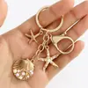 Temu AliExpress Llavero Colgante Estrella de Mar Perla Vieira Cruz Europea Americana Aleación Estrella de Mar Concha Accesorios para Bolsos