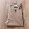 Estación europea de alta gama pantalones casuales color caqui para hombre verano finos de nailon antiarrugas elásticos transpirables rectos holgados