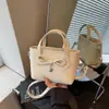 Bolso de Mano Novedoso con Lazo para Mujer 2026 Nuevo Modelo Textura de Cuero Aceitoso Bolso Cubo Moderno para el Trabajo Diario Bolso Cruzado