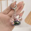 Llavero de Botella de Arena Líquida Negro Dorado Rellena de Aceite Acrílico de Moda Accesorio Colgante de Bolsas de TV de Conejito Lindo de Dibujos Animados
