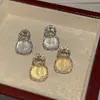 Libro rojo pequeño con pendientes de piedra ojo de gato moda lujo pendientes de diamante de mariposa 2024 nuevos pendientes una generación de pelo