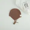 Gorro de lana tejido con protección para los oídos para niños y bebés, transfronterizo, con etiqueta de tela elegante, correas de colores caramelo para niños y niñas