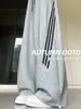Pantalones anchos de rayas estilo americano en gris claro para mujer, nueva colección otoño 2026, de cintura alta, corte holgado, adelgazantes y con una caída fluida