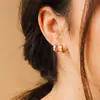 Pendientes de clip de acero inoxidable con diseño de titanio y borde cruzado de Chihang Jewelry. Pendientes de clip de acero inoxidable con borde cruzado redondo y liso.