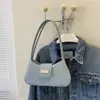 Bolso de axila de nicho estilo francés 2026 nuevo modelo bolso de mano simple bolso de hombro de moda bolso cruzado bolso pequeño para mujer