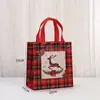 Bolsas de dulces navideños más vendidas transfronterizas, bolsas de embalaje navideño de tela no tejida a cuadros rojos, en stock, impermeables, bolsas de dulces de Halloween
