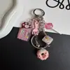 Nueva cadena para teléfono, llavero, colgante para bolso, piruleta de chocolate con forma de pata de gato, hueso de serpiente