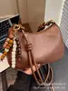 Bolso de axila retro de alta gama para mujer, nuevo y moderno bolso de hombro de nicho 2025 para el trabajo y los desplazamientos, bolso cruzado tipo dumpling