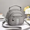 Bolso de mujer 2026 nuevo modelo multibolsillos con cremallera, bolso de mano redondo pequeño, simple y versátil para ir al trabajo, bolso de hombro y cruzado