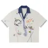 Yidao Vintage 2026 Verano Nuevo Estilo Callejero Americano Estampado de Graffiti Bloque de Color Solapa Casual Holgado Unisex Camiseta de Manga Corta