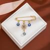 Broche de borla de ojo de diablo con incrustaciones de diamantes, estilo creativo europeo y americano, con sentido avanzado, ojos azules, suéter de cintura ajustada, broche de viento frío