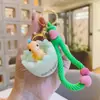 Chaveiro de dinossauro de casca de ovo de desenho animado com música para apertar, boneco descompressor divertido, enfeites para chaveiro de carro, pequeno presente, atacado