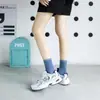 Meias novas femininas cor sólida algodão penteado japonês quatro estações meias cano alto preto e branco JK cor doce meias femininas simples atacado