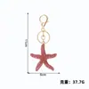 Llavero de Metal Serie Océano Exquisito Llavero de Estrella de Mar con Diamantes Colgante para Coche Colgante de Cadena Conmemorativo de Viaje