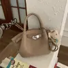 Bolsa Única com Textura Pequena Tote Bag para Mulheres 2026 Estilo Novo da Primavera Bolsa de Cesta Simples Ombro Transversal Bolsa Asa