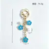 Colgante de llavero de aleación de doble flor más vendido transfronterizo, con lindos accesorios de flor de cerezo y perlas, adecuado para fundas de auriculares y bolsos