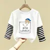 Camiseta de manga larga de algodón puro para niño 2026 primavera y otoño nueva elegante de dibujos animados estilo dos piezas falsas camiseta base de primavera para niño
