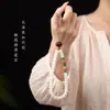 Cordão de celular Bodhi emparelhado com uma pequena fruta de bodhi amarela, uma nova corrente de celular estilo chinês e um acessório de pulso com contas estilo chinês