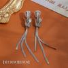 Elegantes aretes largos con borla otoño e invierno lujo ligero alta gama aretes de pin de plata esterlina moda diseño nicho nudo de cuerda clip para la oreja