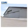 Puertas apilables resistentes al viento para hangares de aeronaves, puertas eléctricas de hangar para fábricas, puertas resistentes al viento suministradas de fábrica con certificación de norma nacional