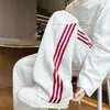 Colección de otoño: Pantalones casuales rectos atléticos para hombre, estilo americano, de corte holgado y pierna ancha, con colores contrastantes y rayas retro.