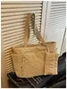 Bolsa de algodón de color liso, simple y elegante, bolso de mano de moda, bolso tote de un solo hombro, para llevar debajo del brazo, nueva versión coreana, primavera 2026