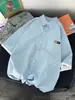 Camisa de manga corta de estilo Hong Kong ins de dos piezas falsas para estudiantes varones, holgada y versátil, chaqueta camisa de manga tres cuartos a la moda