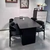 Mesa de comedor negra sencilla con superficie de losa de roca mate, adecuada para apartamentos pequeños, mesa y sillas de comedor de lujo ligero para el hogar