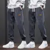 Calça Esportiva Masculina para Adolescentes 2025 Nova Primavera e Outono Caimento Solto Patchwork Com Punho Casual Longa Calça de Veludo Cotele