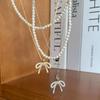 Collar con perlas y lazo de diamantes de imitación de estilo coreano para mujer, cadena elegante con diseño de nicho de lujo y luz.