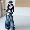 Conjunto de Camiseta de Manga Larga Off-the-Shoulder Falso Dos Piezas Estilo Coreano para Niñas 2026 Pantalones de Pierna Ancha de Mezclilla para Niñas Medianas y Grandes Pantalones Largos