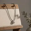 Colar Minimalista Estilo Frio Corda de Couro Preta Pingente Gota de Água Luxo Leve Nicho Corrente Lã 2024 Novas Explosões Senso Sofisticado