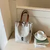 2026 nuevo bolso de lona de color liso, estilo coreano, nicho de moda, moderno, casual, simple, de alta calidad y elegante, bolso tote