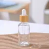 Botella de aceite de esencia transparente vidrio esmerilado líquido de esencia botella para rellenar botella con gotero de cabeza de goma muestra cosmética botella vacía venta al por mayor