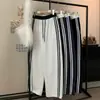 Pantalones deportivos de algodón grises, otoño 2026, diseño a rayas de bloques de color, estilo de pierna curva, pantalones anchos holgados y casuales