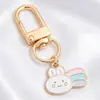 Colgantes de dibujos animados rosas lindos estilo coreano, dijes de aleación de esmalte de conejo y estrella, llaveros con anilla en D, accesorios para manualidades, venta al por mayor
