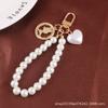Nueva pulsera creativa de perlas con bonito colgante de aleación de corazón, llavero con cabeza de belleza, accesorios de metal, bolso de joyería para mujer