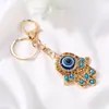 Llavero Colgante Ojo de Demonio de Palma Ojo Azul Pedrería Anillo para Llaves de Coche Colgador Decorativo Portátil Creativo para Mochila
