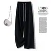 Calça pantalona minimalista estilo japonês para mulheres, com cós elástico de cordão, design plissado e silhueta fluida, perfeita para uso casual na temporada de outono de 2026
