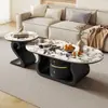Mesa de centro moderna y elegante de pizarra en forma ovalada color crema para salas de estar pequeñas, uso doméstico simple, juego de modelo nuevo
