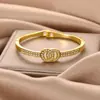 Moda Estilo Coreano Pulsera Cruzada de Doble Círculo de Lujo Ligero Inspirada en Chanel para Mujer, Pulsera Elegante y con Estilo de Aleación al por Mayor