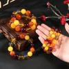 Segunda generación Duobao ámbar cera de abeja flotante fluorescente cuentas redondas amarillo aceite de pollo ámbar sangre ámbar azul pulsera de estilo étnico para hombres y mujeres