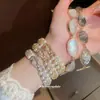 2026 Nuevo Estilo Hebilla de Herradura Pulsera de Perlas de Doble Fila y Circonita Pulsera Elegante Retro Francesa Joyería de Alta Gama