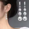 2026 Nuevos Pendientes Largos de Gancho de Perla de Moda Versátiles Adelgazantes para Mujer, Elegantes y Sofisticados Exquisitos Colgantes de Oreja