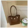 Bolso de hombro con lazo estilo coreano 2026 transfronterizo para mujer, bolso de axila de nicho, bolso tipo cubo moderno y simple para el trabajo diario para mujer