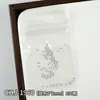 Decorações de arte para unhas com tema oceânico: Designs de estrelas-do-mar douradas e prateadas, conchas e coqueiros em estilo japonês, com apliques metálicos para unhas