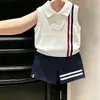 Ropa infantil coreana 2026 verano nuevo estilo chaleco de punto fino con cuello polo blanco conjunto de shorts azul marino para niños
