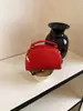 Bolso tejido de lujo ligero de estilo coreano de nicho para mujer, bolso casual tipo concha para el verano 2026, bolso de hombro y cruzado de alta gama