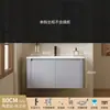 Tocador de baño engrosado y ahorrador de espacio con diseño en color crema, que cuenta con un lavabo redondeado, lavabo cerámico integrado y un lavabo de una sola pieza.