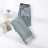 Calça Jeans de Fumaça Enrolada Feminina Nova Primavera e Outono 2025 Cintura Alta Cor Clara Reta Calça French Stick para Homens Baixos